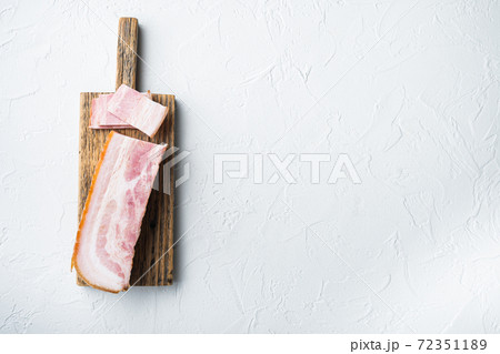 Bacon pancetta cut and sliced on white background, top view with space for text 72351189