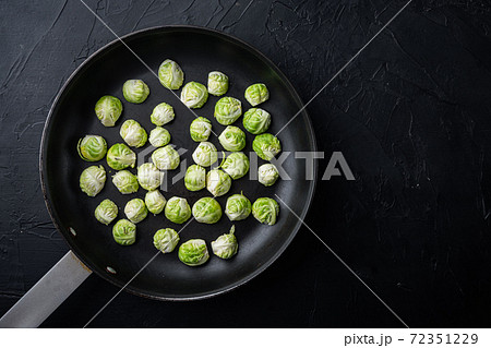 Brussels sprouts, on black textured background, top view with space for text Brussels sprouts, on black textured background, top view with space for text 72351229