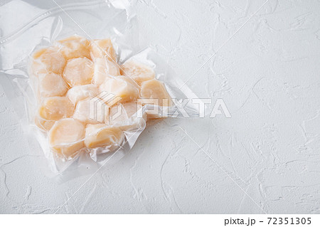 Scallops in vacuum pack, on white textured background with copy space Scallops in vacuum pack, on white textured background with copy space 72351305