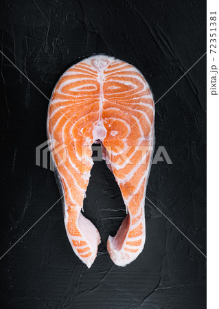 Salmon steak raw fish, over black background, top view 72351381
