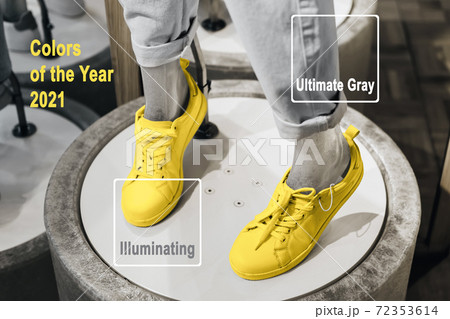 Trending colors of 2021. Illuminating and Ultimate Gray. Mannequin legs in Yellow sneakers on catwalk in store, selective focus Trending colors of 2021. Illuminating and Ultimate Gray. Mannequin legs in Yellow sneakers on catwalk in store, selective focus 72353614