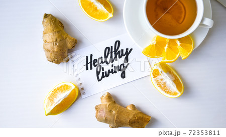 HEALTHY LIVING - written on piece of paper among the products for the treatment of common cold - lemon, ginger, chamomile tea. Vitamin natural drink HEALTHY LIVING - written on piece of paper among the products for the treatment of common cold - lemon, ginger, chamomile tea. Vitamin natural drink 72353811