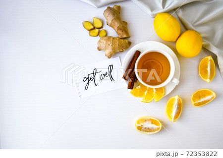 GET WELL - written on piece of paper among the products for the treatment of common cold - lemon, ginger, chamomile tea. Vitamin natural drink GET WELL - written on piece of paper among the products for the treatment of common cold - lemon, ginger, chamomile tea. Vitamin natural drink 72353822