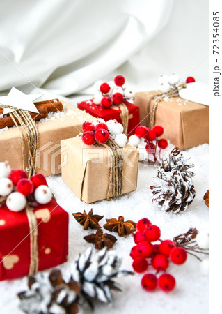 Zero waste Christmas presents with decorations on white snow background. Copy space. Eco friendly packed gifts with tags from craft cardboard Zero waste Christmas presents with decorations on white snow background. Copy space. Eco friendly packed gifts with tags from craft cardboard 72354085