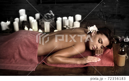Massage woman back in beauty spa with candlelight Massage woman back in beauty spa with candlelight 72356183
