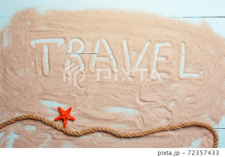Inscription travel on the sand. Starfish and rope Inscription travel on the sand. Starfish and rope 72357433