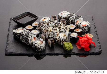 Originally put a set of sushi on a black board. 72357561