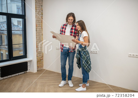 Young couple holding a design project and looking at it 72358204