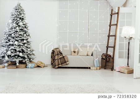 snow Christmas tree with new year gifts in the white room 72358320