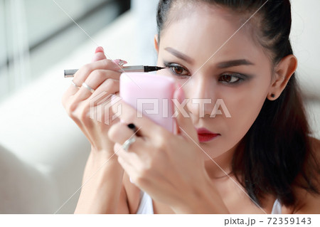 portrait of beauty and young sexy asian girl posting make-up with white vest and blue jean 72359143