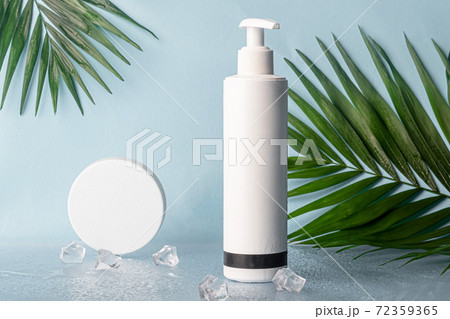 White plastic bottles for creams. On multi-colored backgrounds from Whatman paper. 72359365