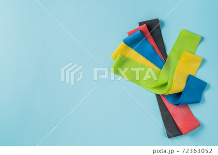 Home training concept - elastic bands on blue background 72363052