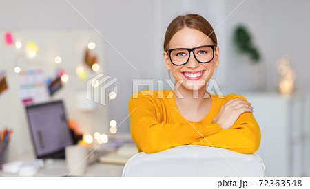 happy smiling freelancer woman in a yellow sweater resting at workplace with Christmas lights. happy smiling freelancer woman in a yellow sweater resting at workplace with Christmas lights. 72363548