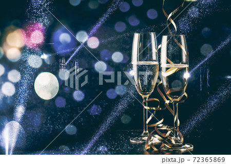 two glasses of champagne in the spotlight - new year celebration two glasses of champagne in the spotlight - new year celebration 72365869