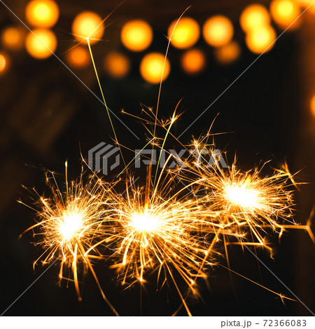 New year Sparklers and orange bokeh background New year Sparklers and orange bokeh background 72366083