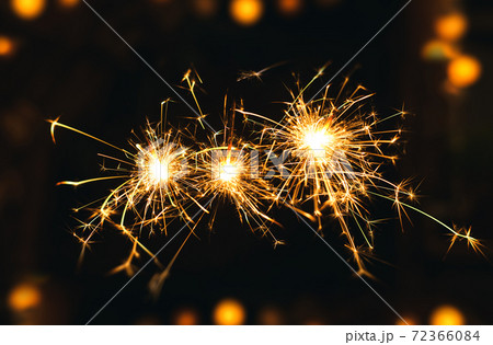 New year Sparklers and orange bokeh background New year Sparklers and orange bokeh background 72366084