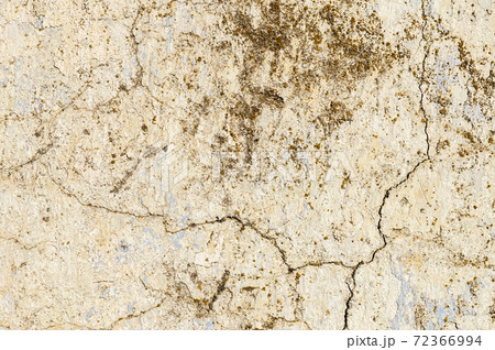 Grunge background of cracked peeling walls with peeled putty in beige tones Grunge background of cracked peeling walls with peeled putty in beige tones 72366994