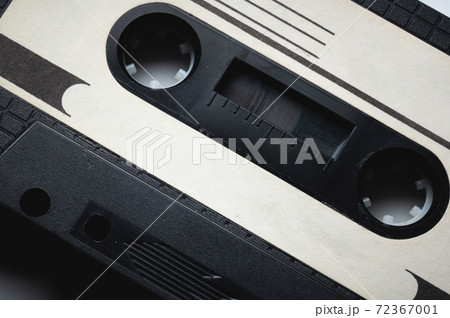 Close-up of a classic audio cassette tape with magnetic tape inside. Retro background 72367001