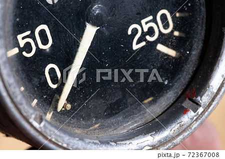 Close-up of an old industrial pressure gauge display with worn protective glass. Macro 72367008