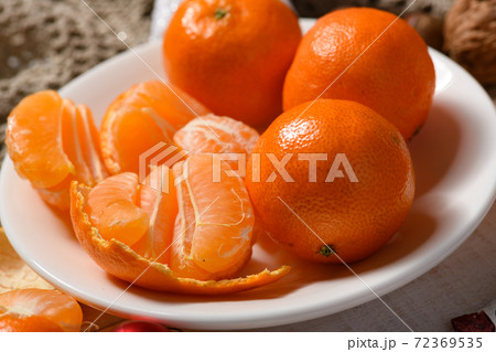 sweet food background for christmas or holiday decoration - chocolate candies, tangerines, nuts and dried fruits on white wood sweet food background for christmas or holiday decoration - chocolate candies, tangerines, nuts and dried fruits on white wood 72369535
