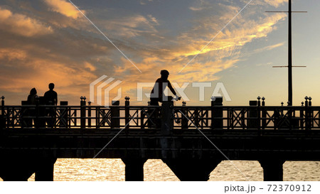 Bangsan Chonburi Thailand jetty and sunset. At Bangsan beach. Ao Thai Ocean. Beautiful sunset landscape, wooden shore jetty and colorful sky and cloud. Artistic beach sunset under wonderful sky. Recre 72370912