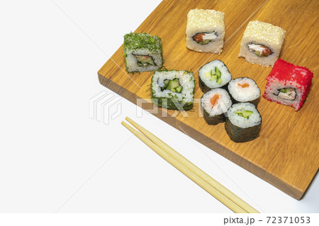 sushi and sticks on a wooden Board on a white background 72371053