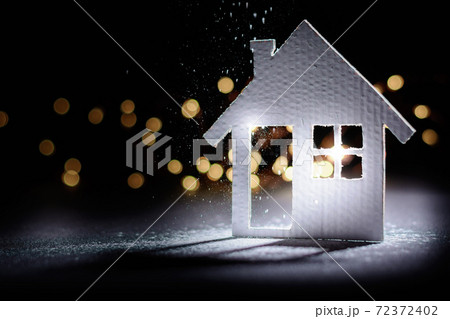 Small cardboard house on a dark winter background. 72372402