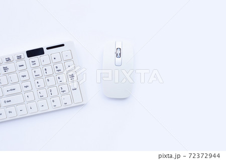 White computer keyboard and mouse on yellow background. Copy space 72372944