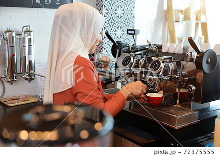 young muslim barista girl making coffee young muslim barista girl making coffee 72375555