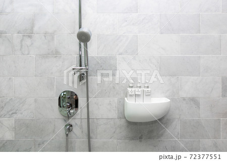 Bathroom hotel amenity, shower gel, shampoo, and conditioner in luxury ceramics container with labels on wooden shelf. Bathroom hotel amenity, shower gel, shampoo, and conditioner in luxury ceramics container with labels on wooden shelf. 72377551
