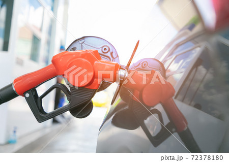 Man pumping gasoline fuel in car at gas station. Transportation and ownership concept. Man pumping gasoline fuel in car at gas station. Transportation and ownership concept. 72378180