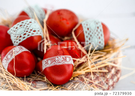 Red Easter eggs in a nest of hay Red Easter eggs in a nest of hay 72379930