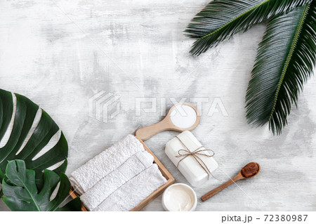 Spa. Body care items on a white background with tropical leaves. Summer accessories. Space for text. Spa. Body care items on a white background with tropical leaves. Summer accessories. Space for text. 72380987
