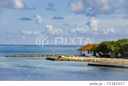 A small marina with a lone house on the Maldives island in the Indian ocean A small marina with a lone house on the Maldives island in the Indian ocean 72381057