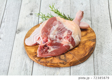 Raw duck leg served rosemary Raw duck leg served rosemary 72385879