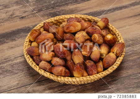 Sweet tasty dry dates in the basket 72385883