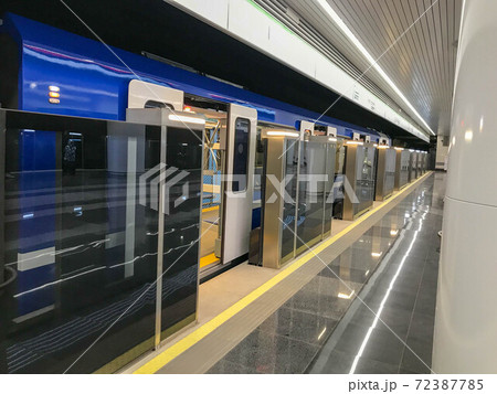 Blue train standing with an open sliding mechanical door at a train station platform. Last stop. Wagons of subway in underground. Rapid transport. High-speed electric train 72387785