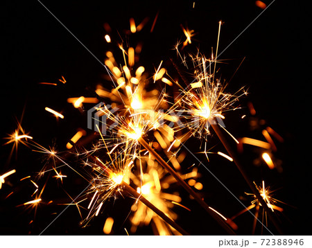 Close up several firework sparklers over black Close up several firework sparklers over black 72388946