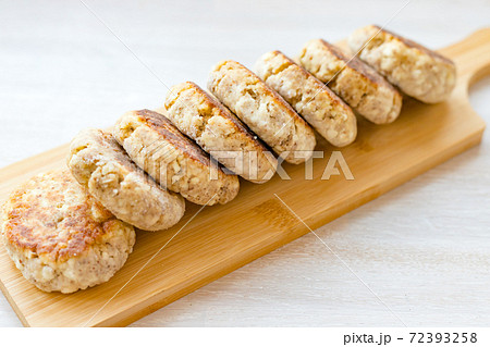 Homemade cottage cheese pancakes syrniki row on wooden cutting Board on white table background Homemade cottage cheese pancakes syrniki row on wooden cutting Board on white table background 72393258