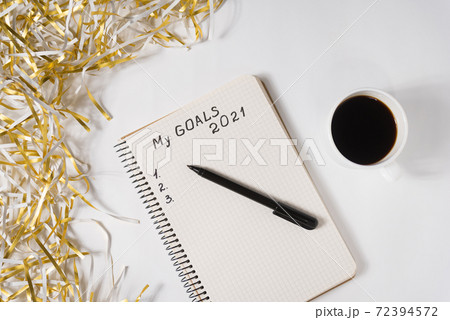 Phrase My Goals 2021 in a notebook, pen. Mug of coffee and tinsel. Top view Phrase My Goals 2021 in a notebook, pen. Mug of coffee and tinsel. Top view 72394572