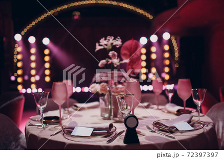 Romantic dinner pink decor table at restaurant with stage Romantic dinner pink decor table at restaurant with stage 72397397