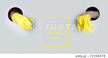 Protective yellow gloves in hand through hole. Protective yellow gloves in hand through hole. 72398078