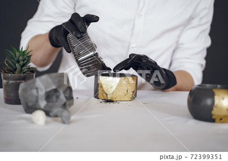 Man in a white shirt works with a cement Man in a white shirt works with a cement 72399351