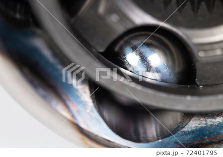 Close-up of a new CV joint on a gray background. Car suspension parts Close-up of a new CV joint on a gray background. Car suspension parts 72401795