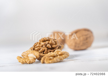 Walnuts kernels on white wooden desk, stock photo Walnuts kernels on white wooden desk, stock photo 72402066