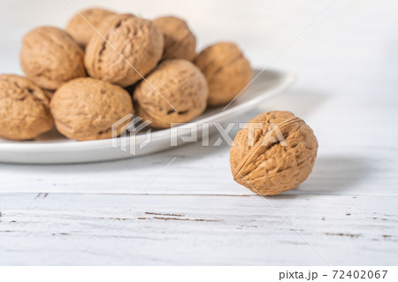Walnuts kernels on white wooden desk, stock photo Walnuts kernels on white wooden desk, stock photo 72402067
