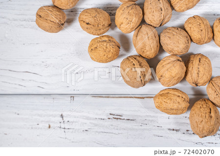 Walnuts kernels on white wooden desk, stock photo Walnuts kernels on white wooden desk, stock photo 72402070