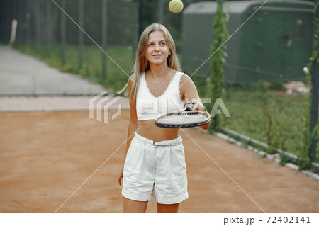 Stylish woman in a summer tennis court 72402141