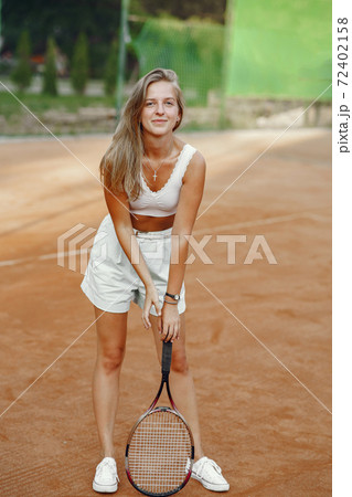 Stylish woman in a summer tennis court 72402158