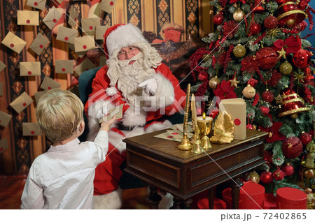 A Boy with Cochlear Implants and Santa Claus 72402865